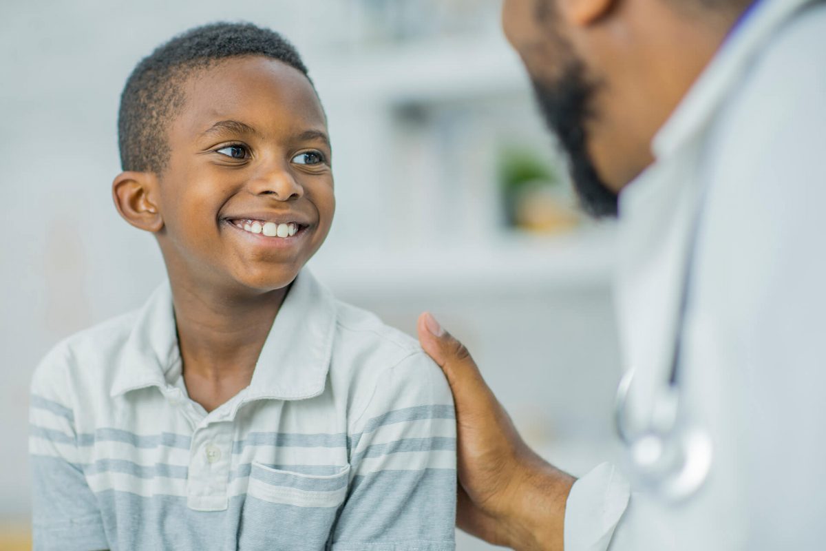 A young boy smiling at the doctor