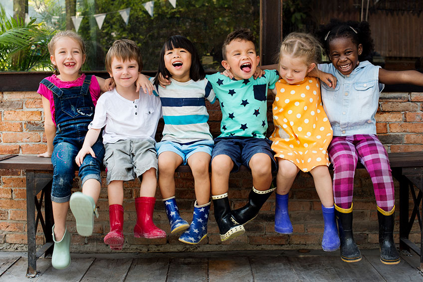 A group of children sitting on the ground.