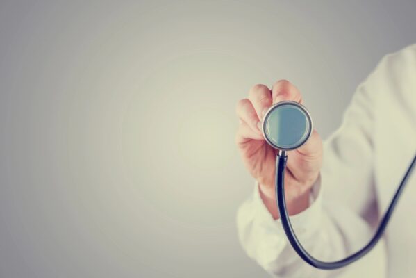 A person holding a stethoscope in their hand.